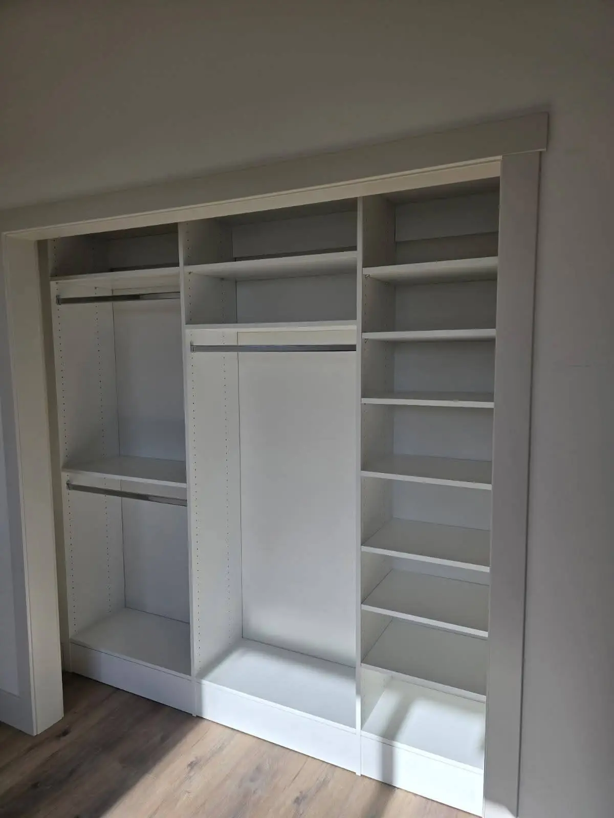 Wide reach in closet system with hanging sections and shelves